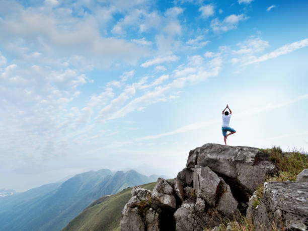 istock Man doing yoga on top of mountain 1177591894