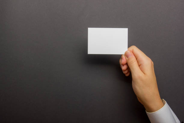 istock Hand holding white business card on white background 1177607497