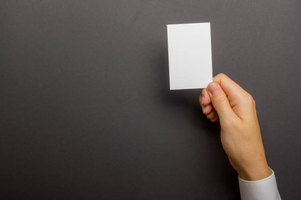 istock Hand holding white business card on white background 1177607623