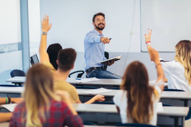 High school students raising hands on a class Group of students raising hands in class on lecture professor photos stock pictures, royalty-free photos & images