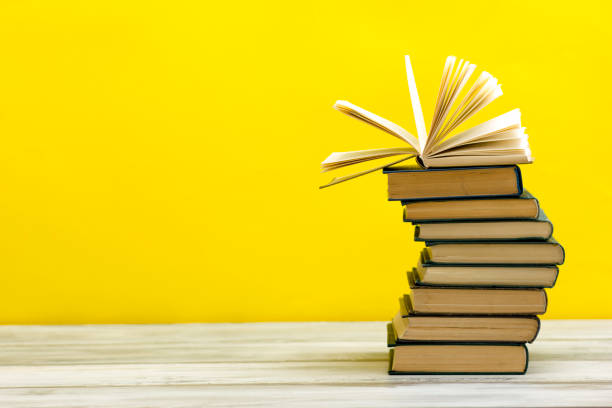 istock Open book, hardback books on wooden table. Back to school. Copy space. 1177608446