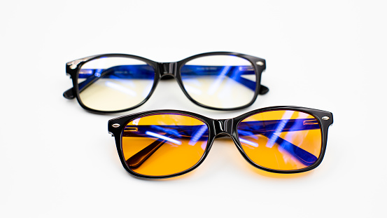 Picture of yellow blue light blocking glasses on white background