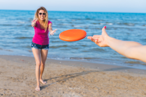 image of a girls playing with flying disc