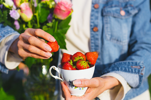 Picture of woman with flowers and strawberries