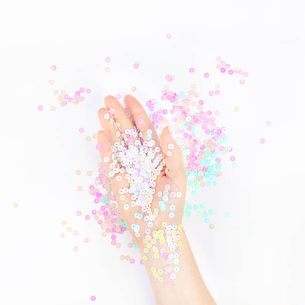 istock Pearl pastel confetti sparkles with woman hand 1177610712
