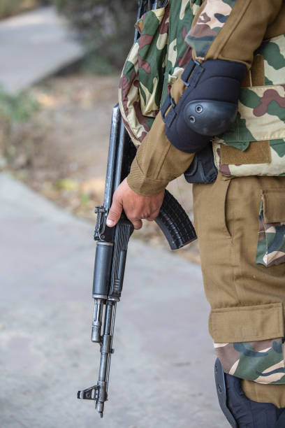 istock Warrior holding a automatic machine gun. New Delhi, India. Closeup 1177612246