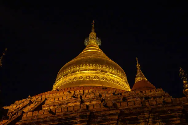 Night scene of the Shwezigon golden pagoda, famous for its gold-leaf stupa in Bagan, ancient city of Myanmar, Burma