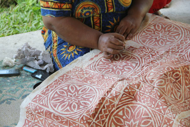 istock A Samoan lady drawing traditional pattern with mud water on a handmade mulberry paper. 1177612359