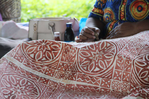 istock A Samoan lady drawing traditional pattern with mud water on a handmade mulberry paper. 1177612387