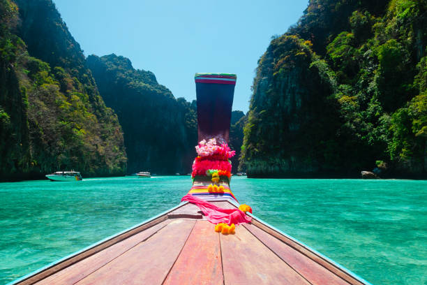 istock Longtail boat in a blue lagoon in Thailand 1177616139