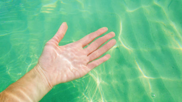 istock hand in clear ocean water 1177616275