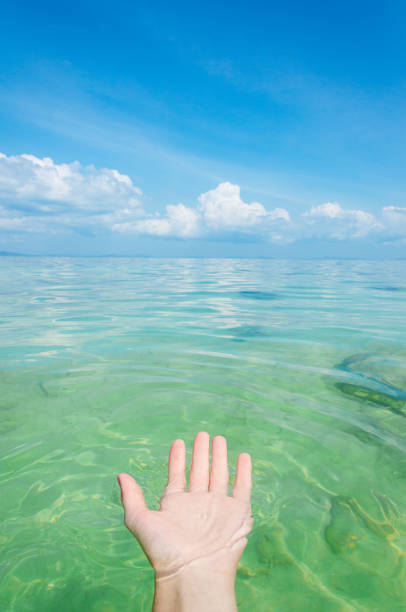 istock hand in clear ocean water 1177616412