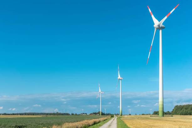 istock Wind turbines in agricultural fields on blue and cloudy sky background. Clean and renewable energy concept 1177618528