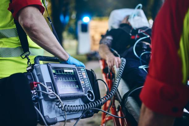 Team of emergency medical service Team of emergency medical service rescuing old patient. Selective focus on heart rate monitor. heart attack stock pictures, royalty-free photos & images