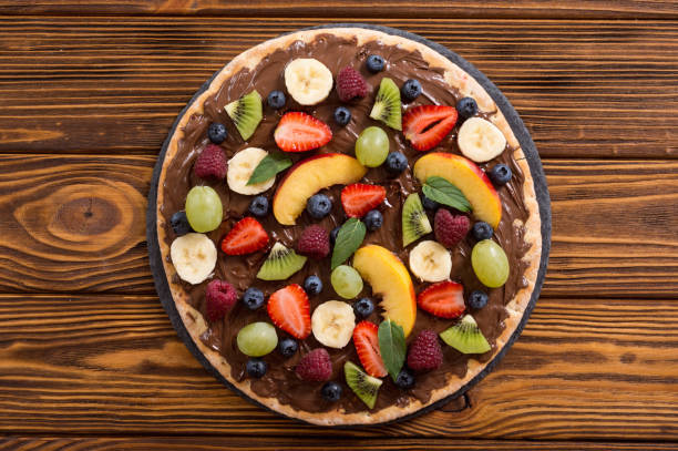 Fruit pizza with nut nougat cream , fruit and berries