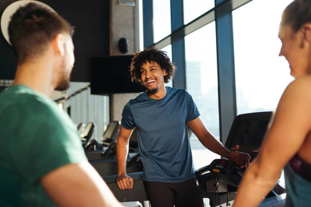 istock Young cheerful people resting from exercising at gym and communicating 1177620053