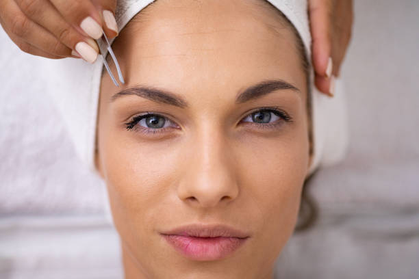 istock Beautiful young woman gets eyebrow correction procedure 1177621475