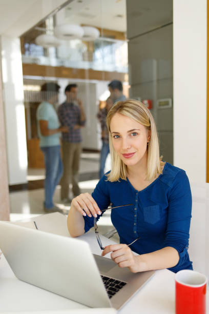 istock Successful young woman in modern office working on laptop 1177622531