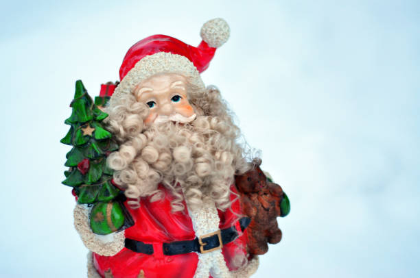 istock Small festive Father Christmas model in the snow 1177622983