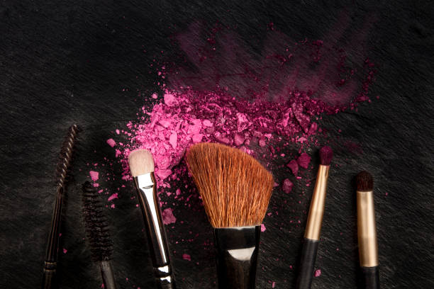 istock Make-up brushes with crushed cosmetics, shot from above on a black background with a place for text, a beauty design template for a makeup banner 1177623714