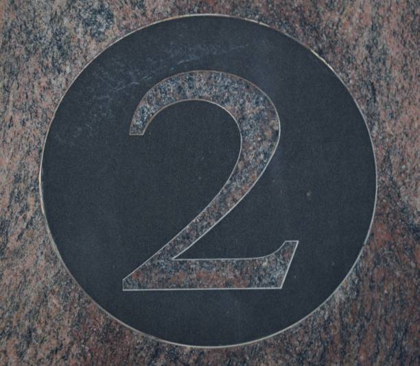 istock Number 2 in pink marble inside a circle of black marble 1177628319