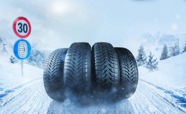 istock Car tires on snowy roadway 1177629525