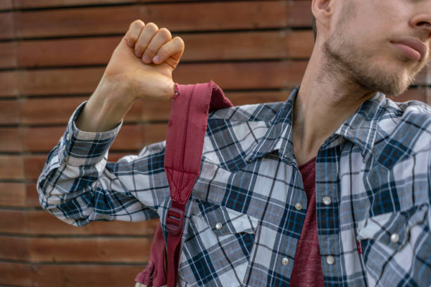 istock hand with  red backpack on a hiking vacation, moving to journey 1177630333