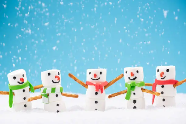 Photo of Happy Marshmallow Family Play in Snow. Funny Festive Christmas Card