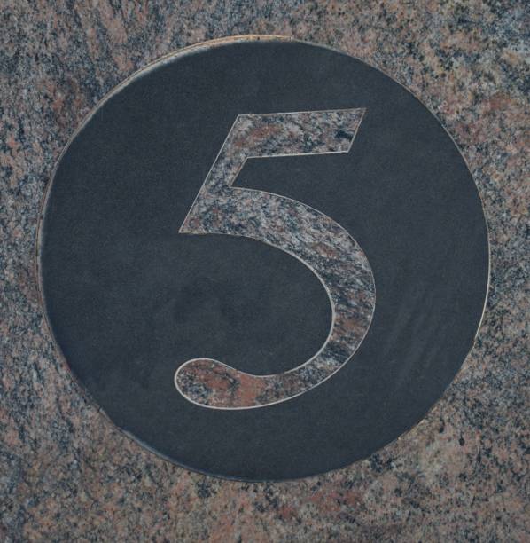istock Number 5 five in pink marble inside a circle of black marble 1177630425