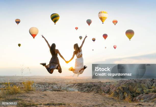 Girlfriends Traveling And Enjoying Valley View At Sunset In Cappadocia Stock Photo - Download Image Now