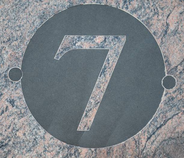 istock 7, Pink marble number within a circle of black marble 1177630832