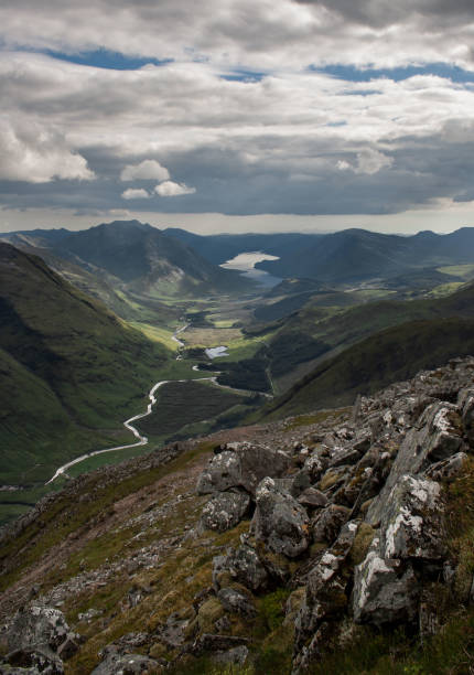 Landscape view of Glen Etive from the Buachaille Etive Beag with rocks in the foreground, in Glencoe. Scotland. Highlands View of the valley of Glen Etive from the Stob Dubh peak, summit of the Buachaille Etive Beag, with Loch Etive in the background and rocks in the foreground. Highlands of Scotland. Munros. Hiking. Hill Walking. buachaille etive beag photos stock pictures, royalty-free photos & images