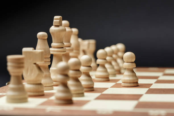 istock chess pieces on a chessboard, against a dark background. 1177633749