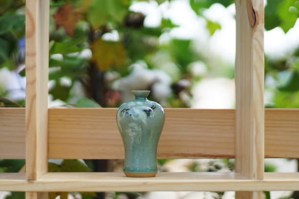 istock A celadon mug and teapot set with flowers outdoors. 1177635210