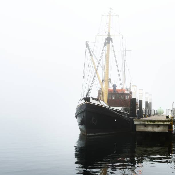 istock A pier with small boats under fog 1177640435