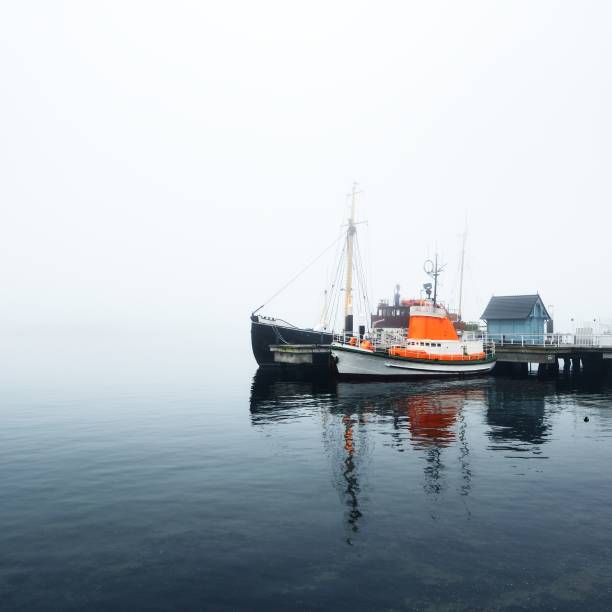istock A pier with small boats under fog 1177640446