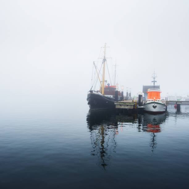 istock A pier with small boats under fog 1177640447