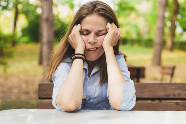 istock Tired woman sleeping with hands on a table outdoors 1177641684