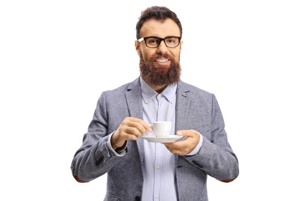 Cheerful bearded man with a cup of espresso coffee looking at the camera isolated on white background