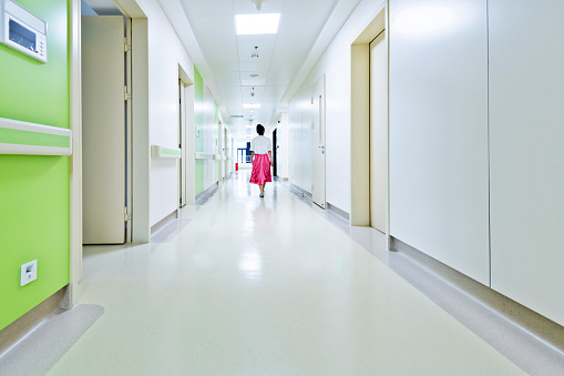 Women walking in hospital corridor.