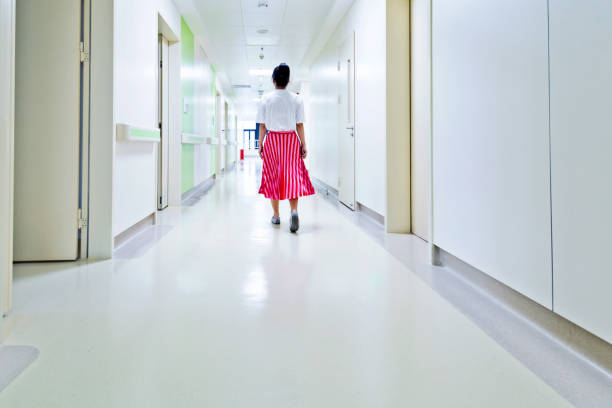 Women walking in hospital corridor.