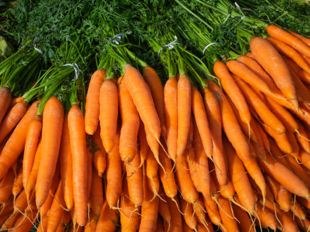 istock Market stall with fresh carrots high angle view outdoors 1177644627