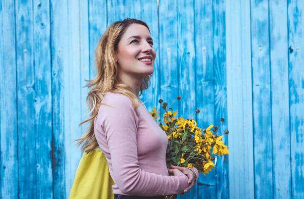 istock Beautiful woman with yellow flowers 1177647543