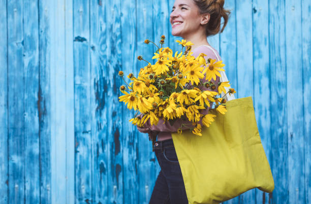 istock Beautiful woman with yellow flowers 1177647619