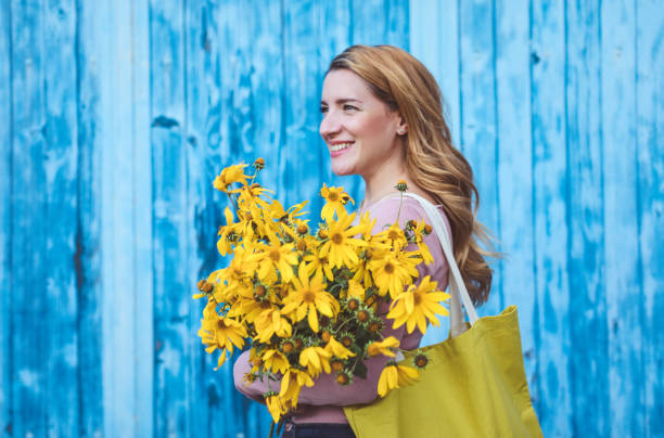 istock Beautiful woman with yellow flowers 1177647819