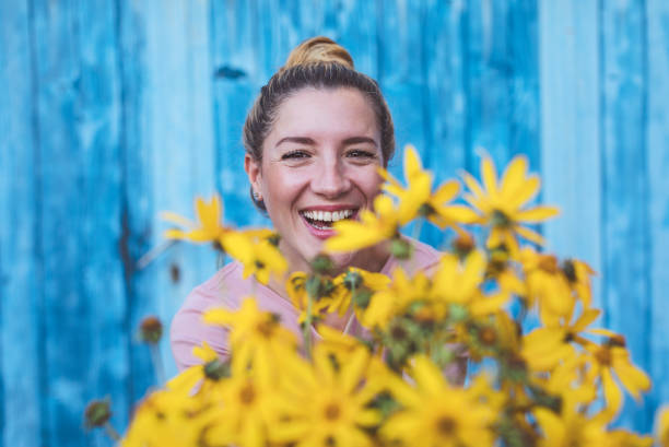 istock Beautiful woman with yellow flowers 1177647916