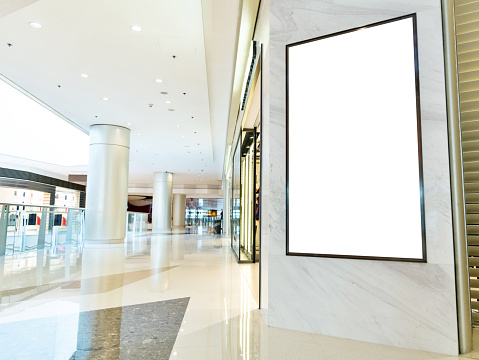 Blank billboard in modern shopping mall.