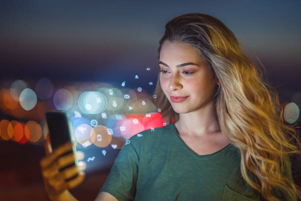 istock Young Woman Using Smart Phone In City At Night 1177651556
