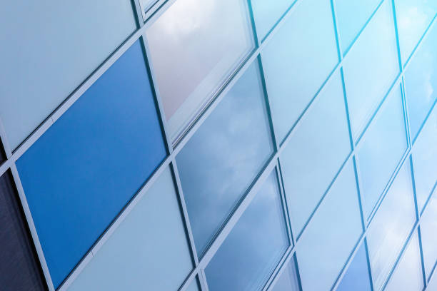 istock Close-up of glass wall surface with blue sky reflection. 1177654450