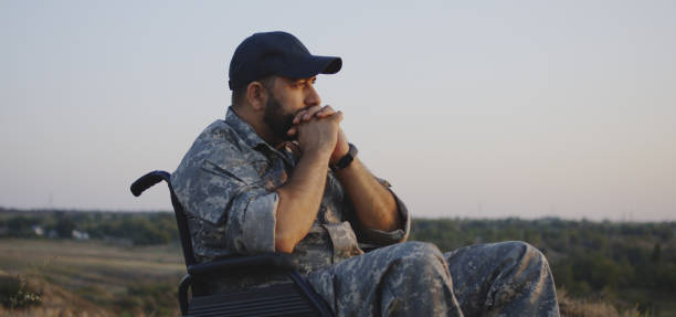 istock Wheelchaired soldier looking away into distance 1177656536